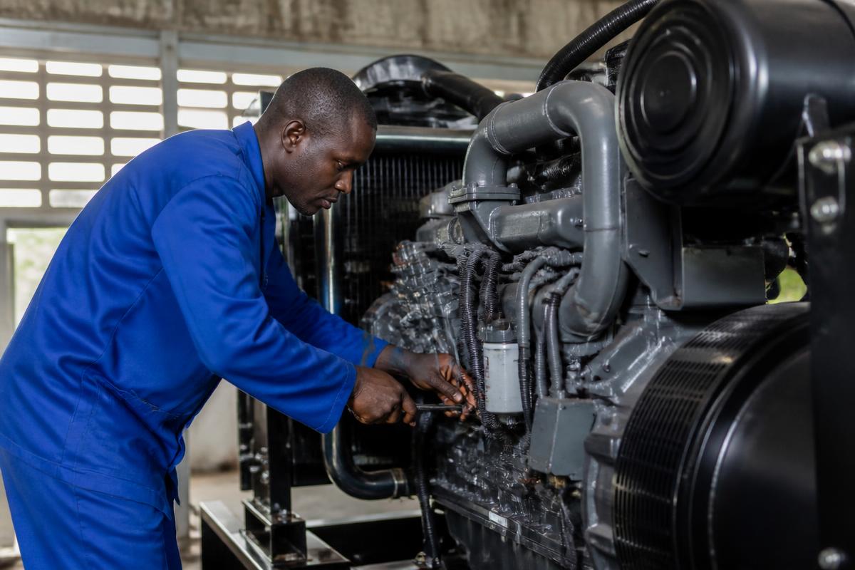 Technician carrying out generator repairs and servicing for Kenbel in Lagos